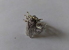 a silver ring with a bee on it