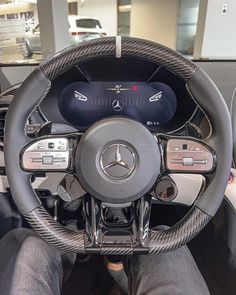 the interior of a car with steering wheel and gauges on display in a showroom