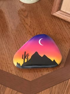 a painted rock sitting on top of a wooden table