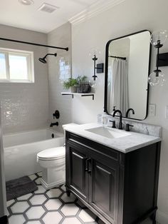 a bathroom with a sink, toilet and bathtub in the middle of the room