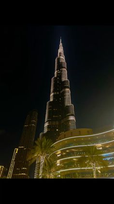 the burj building is lit up at night