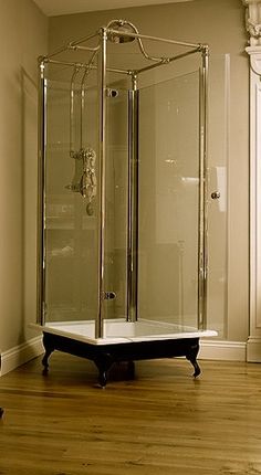 a bathroom with a stand up shower and wooden floors