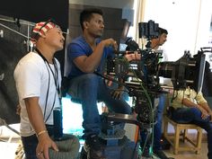 three men sitting in front of a camera