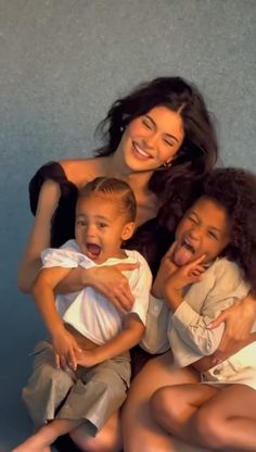 three women and two children are posing for a photo with one child on his lap