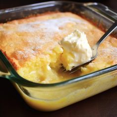 a fork is in a casserole dish with cream on the top and side