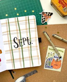 an open notebook with the word sipf on it next to some pens and scissors