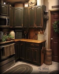 a kitchen with brown cabinets and wooden counter tops is shown in this image, there is a clock on the wall above the cupboards