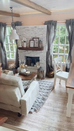 a living room filled with furniture and a fire place