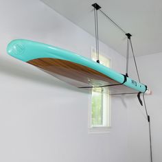 a surfboard hanging from the ceiling in a room