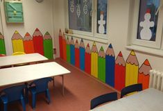 a classroom with colorful crayons painted on the walls