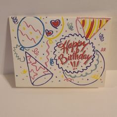 a happy birthday card with balloons and confetti on the front, in bright colors