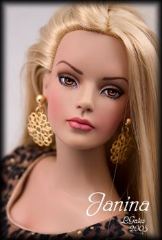 a mannequin head with long blonde hair and leopard print dress, wearing gold earrings