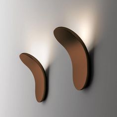 two brown curved objects are on the wall