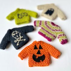 knitted halloween sweaters and mittens with jack - o'- lantern faces