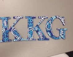 the letters k and g are made out of blue paisley print fabric on a computer keyboard