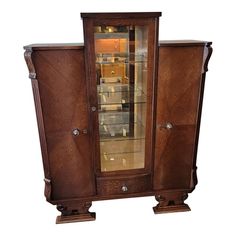 an antique display cabinet with glass doors and wooden legs, in the manner of art nouveauism