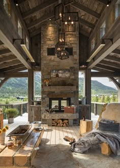 a living room filled with furniture and a fire place in the middle of an open floor plan