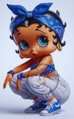 a little doll with big blue eyes sitting on top of a white surface and wearing a blue headband