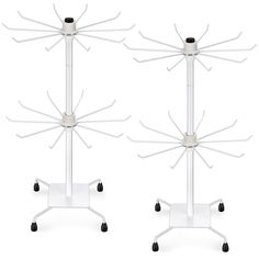 two white stands with wheels on each side and one is holding an object in the middle