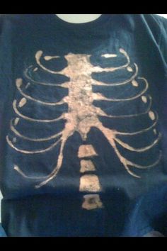 a man wearing a t - shirt with a skeleton design on it's chest