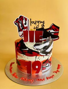 a birthday cake decorated with shoes and happy new year lettering