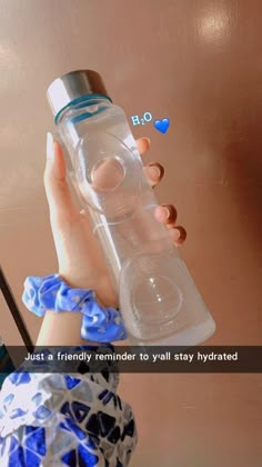 a woman holding a water bottle in her hand with the caption just a friendly reminder to visit stay hydrated