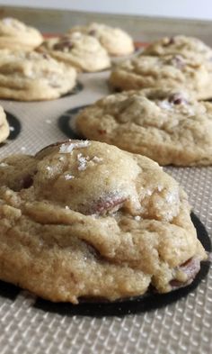 chocolate chip cookies are cooling on a baking sheet, ready to go into the oven