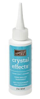 a bottle of crystal effects glue on a white background with the words crystal effects written in it