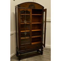 an old wooden bookcase with glass doors