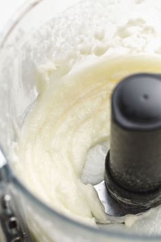 a blender filled with white liquid on top of a counter