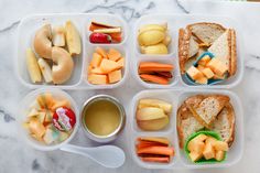 a plastic container filled with lots of different types of food on top of a table