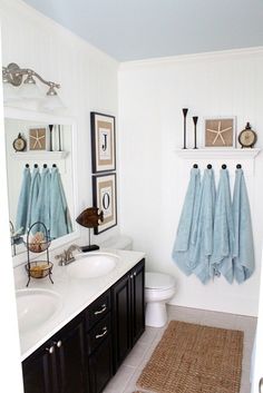 a bathroom with blue towels hanging on the wall