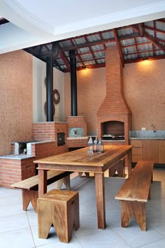 a kitchen with an oven, table and benches