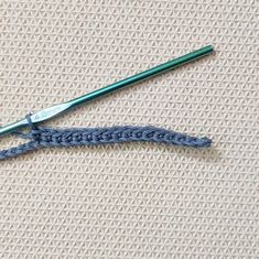 two crochet hooks are laying on the fabric