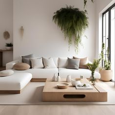 a living room with white couches and wooden coffee table in front of a large window