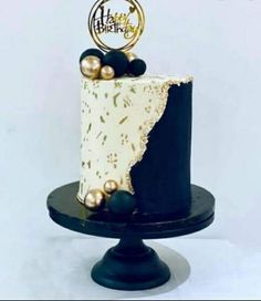 a black and white cake with gold decorations