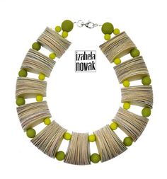 a necklace made out of books with green beads