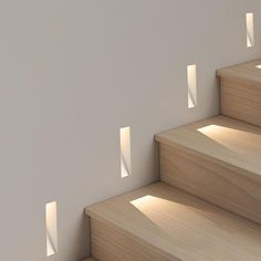 the light is shining through the windows on the stairs