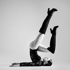 a woman is doing a handstand on one leg with her legs in the air