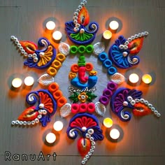 an intricately decorated diya with lit candles