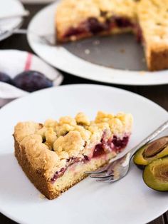 a piece of pie on a plate with a fork and an avocado next to it