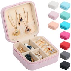 an open jewelry box filled with lots of different colored necklaces and rings in it