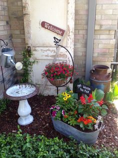 a welcome sign and potted plants in front of a building with flowers growing out of it