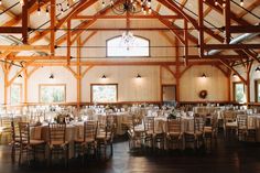 the inside of a building with tables and chairs set up for a formal function,