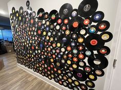 a wall with records on it in an office