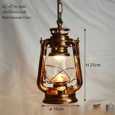 an old fashioned light hanging from the ceiling with measurements to show it's size