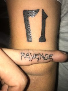 a person with a tattoo on their arm that reads 1, 7 and the number seven