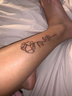 a person laying in bed with a tattoo on their arm that says love and an elephant