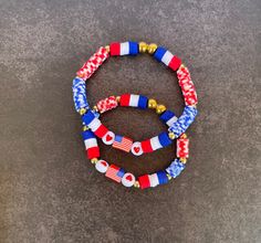 two red, white and blue beaded bracelets sitting on top of each other