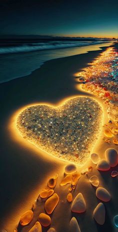 a heart shaped light on the beach at night